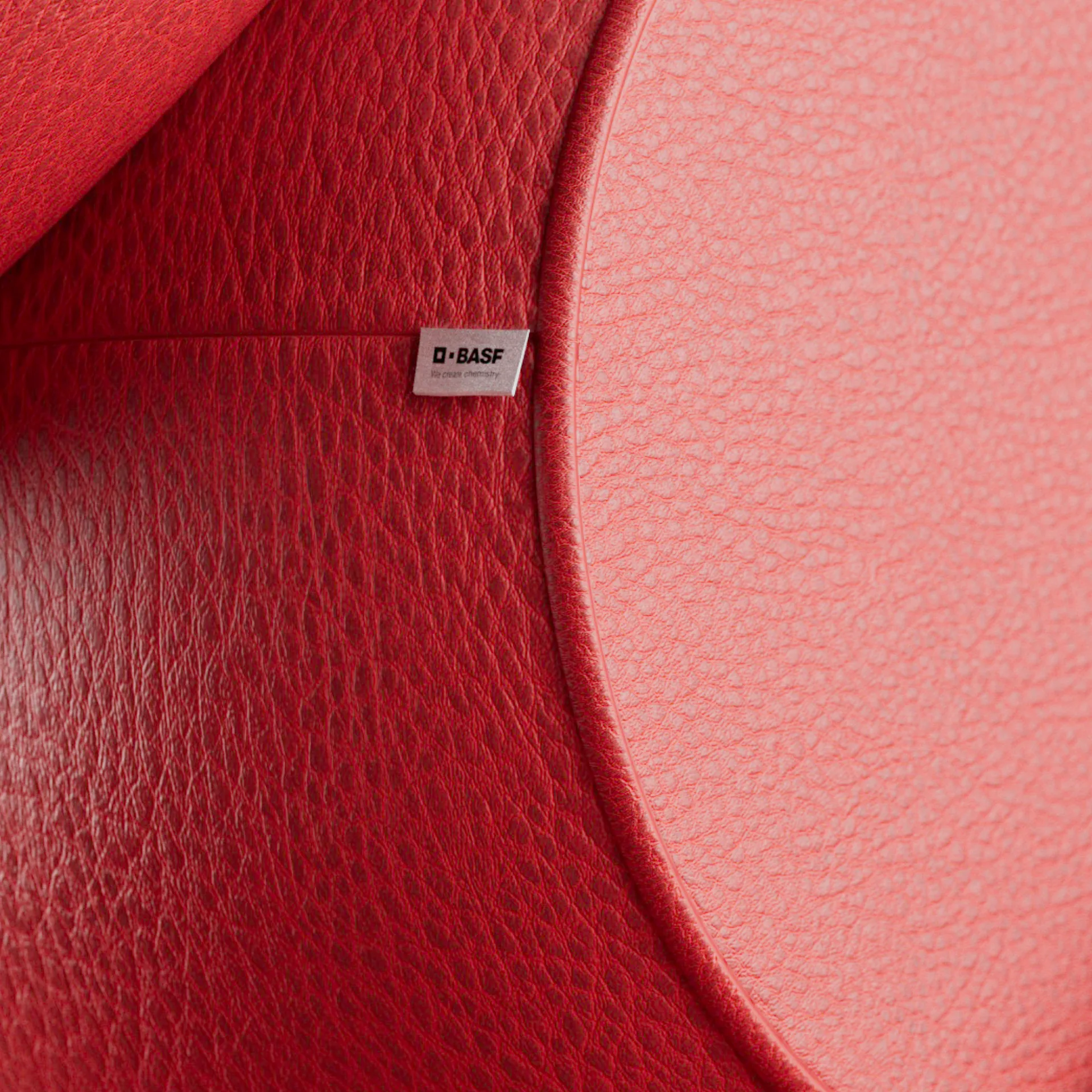 Close up of red textured synthetic material with BASF branding tag, part of 3D animation series showcasing future materials in the Design Fabrics campaign